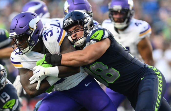 Seattle Seahawks linebacker Levi Bell (98) tackles Minnesota Vikings running back DeWayne McBride (37) during the first half at Lumen Field.